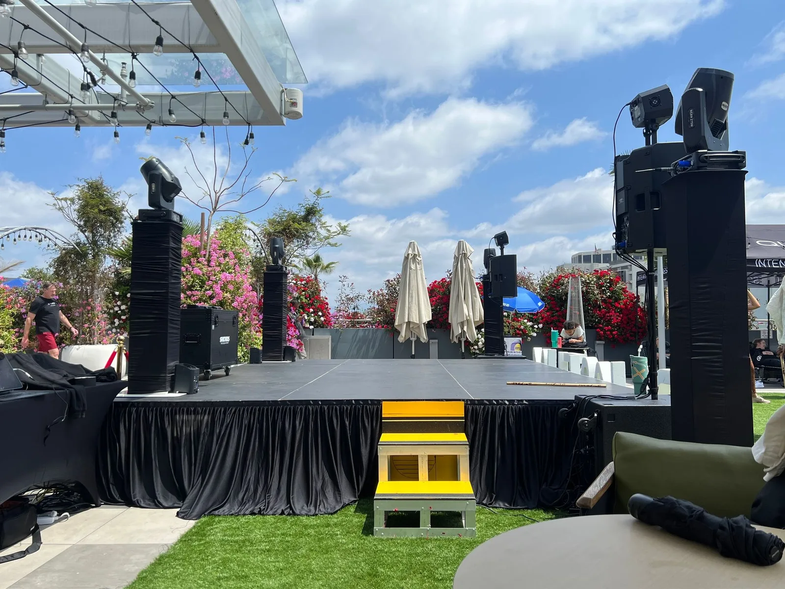 Professional QSC speaker system set up on an outdoor stage